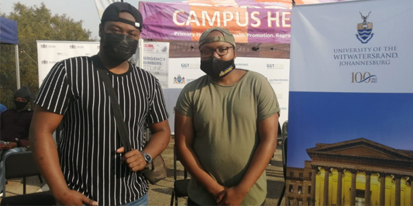(l-r) Protected from the virus Tisetso Leshilo and Nare Moseu place trust in science